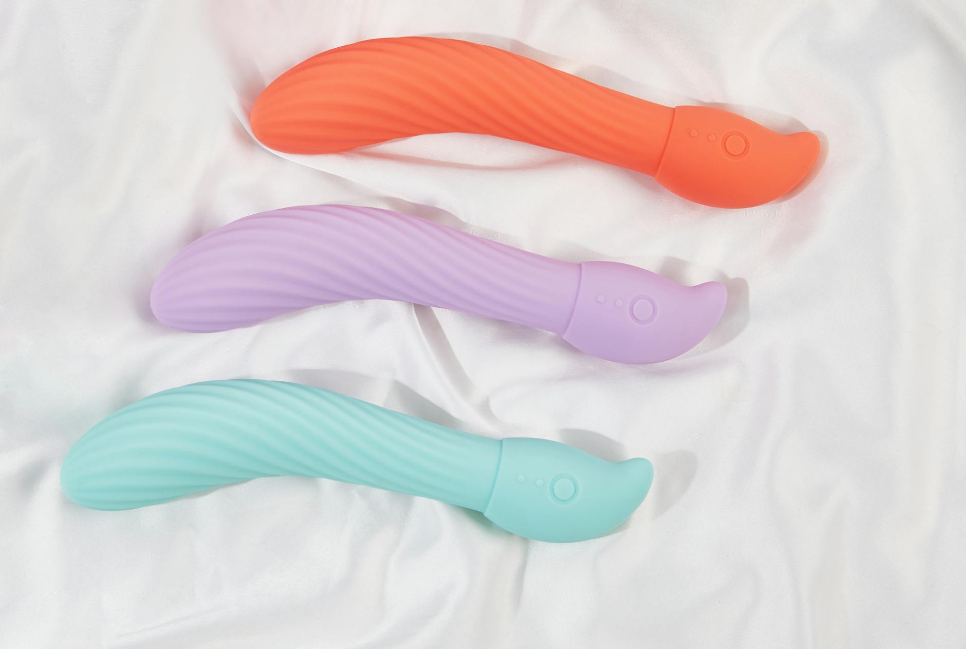 Pink vibrator on a purple background with heart confetti and candles, representing taking time for pleasure without rush