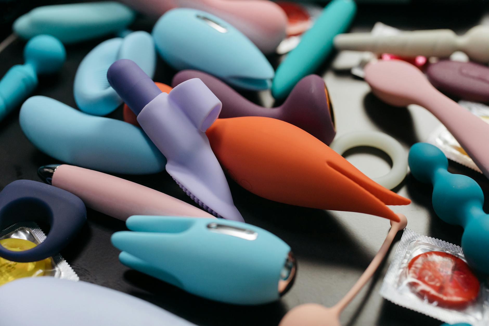 An array of vibrant adult toys including clitoral vibrators in a close-up view.